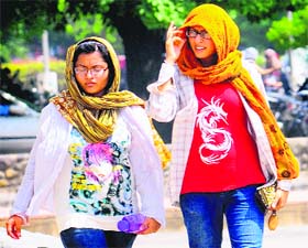Girls fully draped in clothes to protect themselves from the scorching sun in Chandigarh