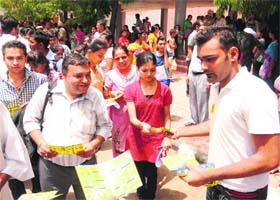 Student leaders distribute pamphlets among students outside their examination centre at Panjab University on Sunday