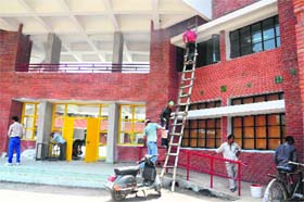 Workers give the finishing touches to the Government High School building in Sector 54, Chandigarh