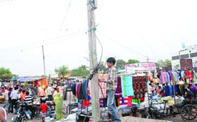 A young boy attaches a kundi connection for his shop at Colony No 4 in Industrial Area, Phase 1, Chandigarh