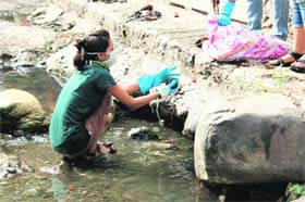 A cleanliness drive by MAD volunteers under way at Tamsa stream in Dehradun on Sunday
