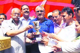 MC President Manmohan Singh Mall presents the winning trophy to the Cricket League winners in Mussoorie on Sunday