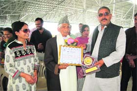 Municipal Council president Manmohan Singh Mall felicitates a social activist