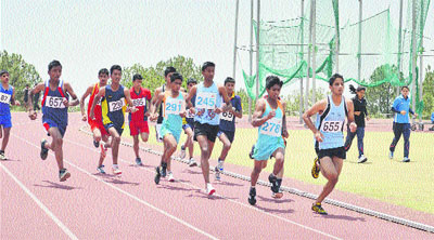 Boys participate in a 5,000-m race at the state-level athletics meet organised in Dharamsala on Saturday. 