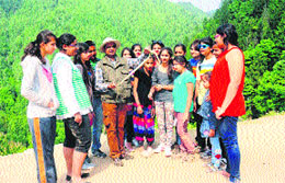 Naturalist Chandresh Lodhiya shows a snake to students at a camp near Punjpulla in Dalhousie.