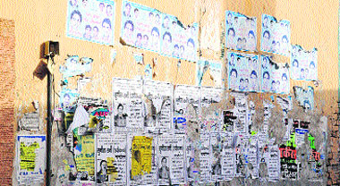 A view of a wall defaced by posters of candidates contesting the Municipal Corporation elections in Hisar.