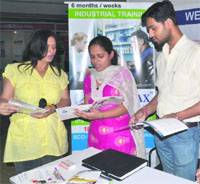 A representative of an educational institute interacts with students during an education exposition at Omaxe Plaza in Ludhiana. Different educational institutes had set up over 25 stalls at the expo, which attracted as many as 1,500 visitors.