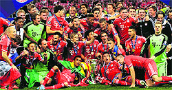 The team posing with the trophy