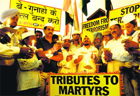  Members of the All India Anti-Terrorist Front (AIATF) hold a candlelight vigil while paying tribute to Congress leaders killed in a Maoist attack in Chhattisgarh, in Amritsar on Monday.