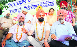 Members of Guru Nanak Dev University Teachers Association address mediapersons in Amritsar on Monday.