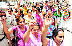 Special trainer teachers from Faridkot jail raise slogans against Punjab government after being produced in a court in Bathinda on Monday