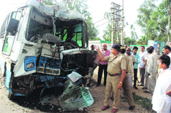 The mangled remains of the Haryana Roadways bus that rammed into a pillar on the NH-1 near the Ambala Cantonment railway station on Monday.