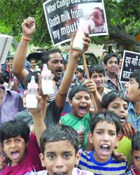 Children take part in a protest against the hike in Mother Dairy milk prices, at Jantar Mantar in New Delhi on Monday