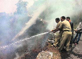 A fire-fighting operation going on with the help of fire tenders at the Chondi-da-Phat forest near Chamba on Sunday