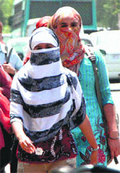 Girls cover themselves to stay away from scorching heat in Gurgaon. 
