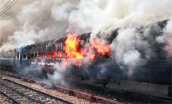 A train on fire at the Jammu railway station on Sunday.