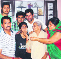 Himani Badyal celebrates with her family members. 