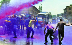 Police sprays coloured water on them in Srinagar on Monday.