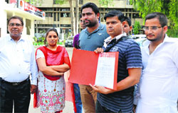 Persons who were duped by a swindler on the pretext of getting them modelling and acting assignments outside the Police Commissioner's office in Ludhiana on Monday. Photo: Inderjeet Verma