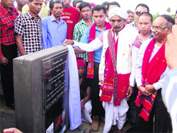 Rechno Haising Ronghang, titular king of Karbi Anglong, unveils the plaque at the relocation site for Ram Terang village on Monday. 