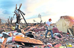 A man recovers his belongings from a tornado-ravaged home early on Monday in Moore, Oklahoma.  AFP