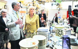 Camilla, Duchess of Cornwall (C), during her official visit to the charity association Emmaus' second-hand store in Bougival, west of Paris, on Monday.  AFP