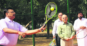 VK Singh (left), Finance Secretary, plays an exhibition match with CLTA officials during the inaugration of a tennis court at the GMSSS-23, Chandigarh, on Tuesday. 