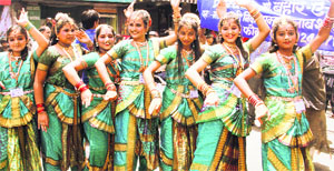 Girls perform during a nagar parikarma as part of the All-India Dance Competition in Dehradun on Tuesday.