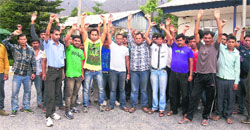 Employees of AEPPL stage protest outside Konkan Railway office at Reasi on Tuesday. A Tribune photo
