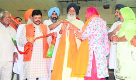 Chief Minister Parkash Singh Badal and BJP state president Kamal Sharma felicitate newly elected zila parishad members at a function in Chandigarh on Tuesday