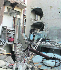 Buildings damaged by what activists said was shelling by forces loyal to Syria's President Bashar al-Assad in the besieged area of Homs on Tuesday.