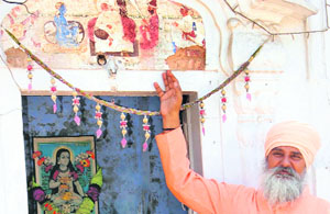 Mahant Nihal Dass shows the rare fresco at the Golden Temple in Amritsar on Wednesday. 
