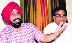 Raj Kanwal Preet Pal Singh Lucky (left), leader of the opposition in the MC House,  addresses mediaperson in Amritsar on Wednesday. 
