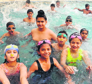 Children enjoy swimming during a camp at Daddy's Teddy Playway School in Bathinda on Wednesday.