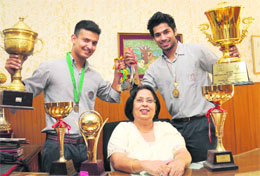 National-level tennis players Digvijay Singh Mehta (left) and Digvijay Singh Naruka, who performed well in the CBSE Class XII board exams, along with their school principal at DAV School, Sector 15, in Chandigarh.