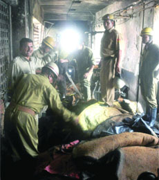 Firefighters and the Delhi Police look for any victim  after dousing the fire at Guru Teg Bahadur Hospital in New Delhi on Wednesday.  