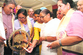 Daljit Kaur, sister of Sarabjit Singh, who died in a Pakistani prison, lights the traditional lamp at a function organised by Uttaranchal Punjabi Mahasabha in Dehradun on Wednesday. 