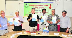 Prof Furqan Qamar, Vice-Chancellor, releases a compendium of resources on research methodology at the CUHP on Wednesday. Photo: Ashok Raina