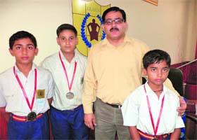 Players with the school principal after winning the inter-school district-level boxing tournament in Jammu on Wednesday