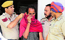 Policemen arrest murder accused Puran Chand in Jalandhar on Wednesday