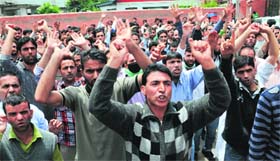Daily wagers of the Floriculture Department shout slogans during a protest rally in Srinagar on Wednesday
