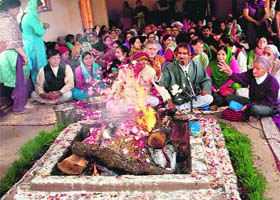 Pandits perform pooja at the Zeshta Devi Temple in Srinagar during a maha yagna at the temple, located on the foothills of the Zabarwan mountain range, to mark the birthday of goddess Zeshta Devi