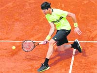 Milos Raonic of Canada, the 14th seed, beat Michael Llodra of France 7-5, 3-6, 7-6, 6-2 to enter the third round of the French Open on Wednesday