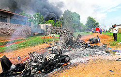 Motorcycles and houses destroyed in a fire after a riot in Lashio township on Wednesday