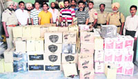 Officials of the Excise Department with the illegal liquor seized during a raid at Chheharta area in Amritsar on Thursday