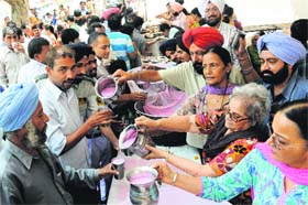 Providing relief to parched throats: Residents serve sweetened water to commuters in front of the Government Super-speciality Hospital, Sector 16, Chandigarh, on a hot Thursday afternoon