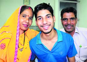 Lokesh Kumar, son of a supervisor with a private security agency and a student of the GMSSS, Sector 16, Chandigarh, celebrates his success (9.4 CGPA) with his parents