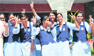 Students show victory sign after getting CGPA-10 in CBSE Class X results at Dyal Singh School in Karnal on Thursday. 