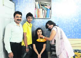 Family members of Aishwarya Puri offer her sweets in Sirsa