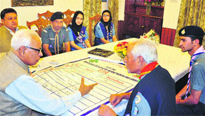 Governor NN Vohra interacts with scouts and guides at Raj Bhawan in Srinagar on Thursday. 